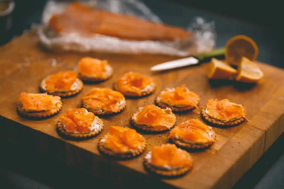 a wooden cutting board topped with small crackers